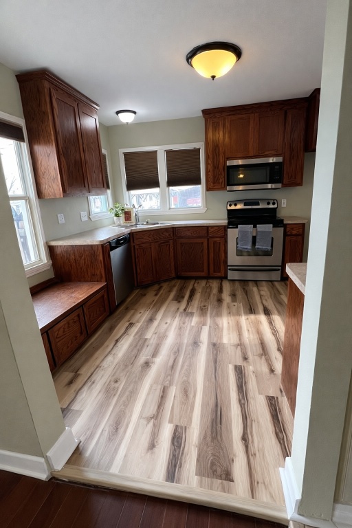 305 West Davilla Street Granger, TX 76530 - Photo 6 of 20 a kitchen with wooden cabinets and stainless steel appliances