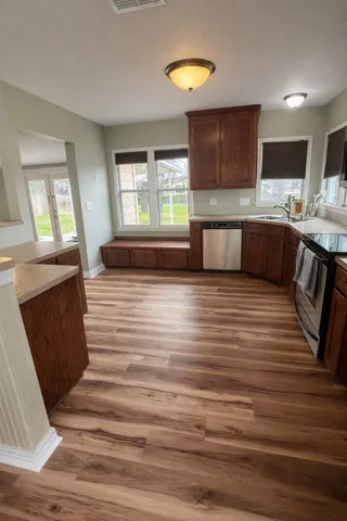 a bedroom with bed and wooden floor
