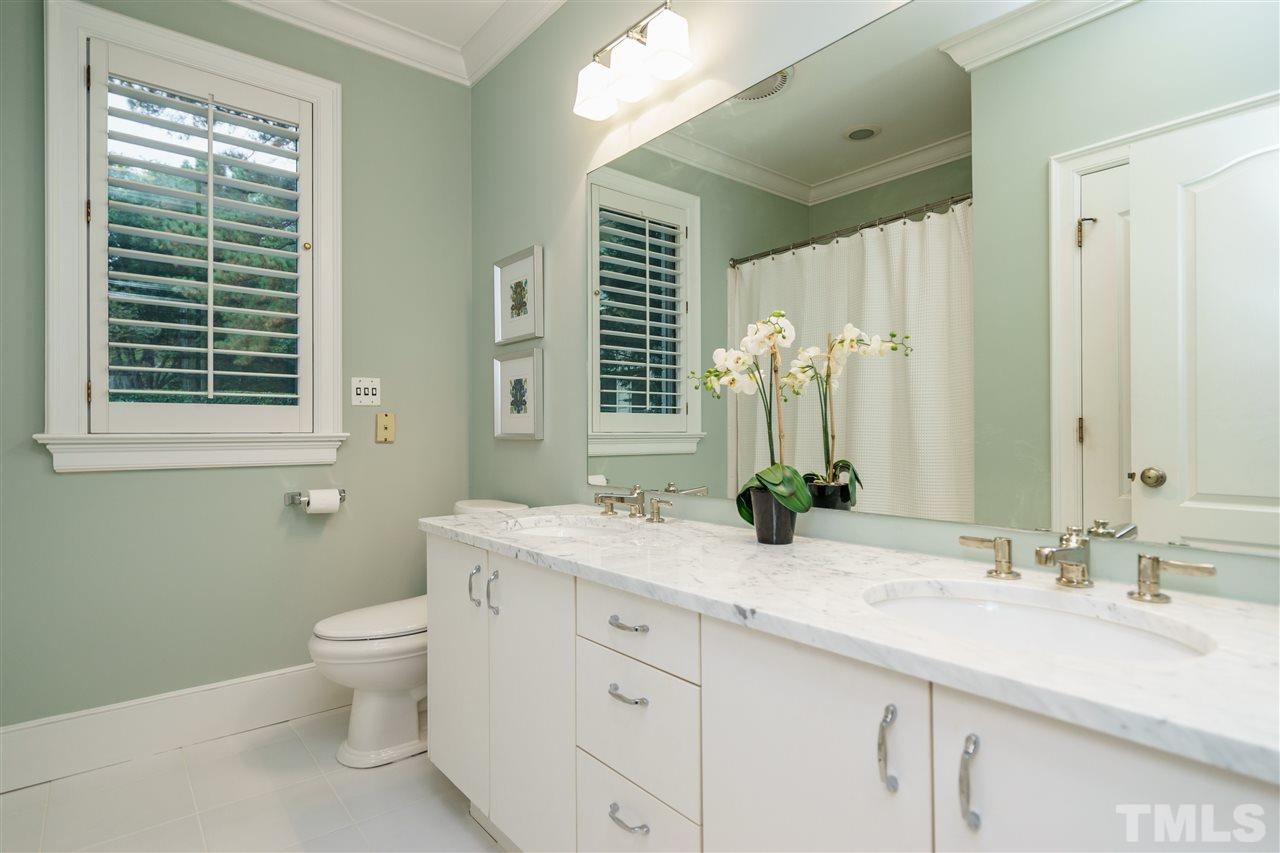 7628 Rainwater Road Raleigh, NC 27615 - Photo 11 of 25 a bathroom with a granite countertop sink toilet and a mirror
