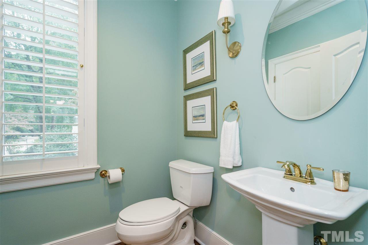 7628 Rainwater Road Raleigh, NC 27615 - Photo 14 of 25 a bathroom with a sink toilet and mirror