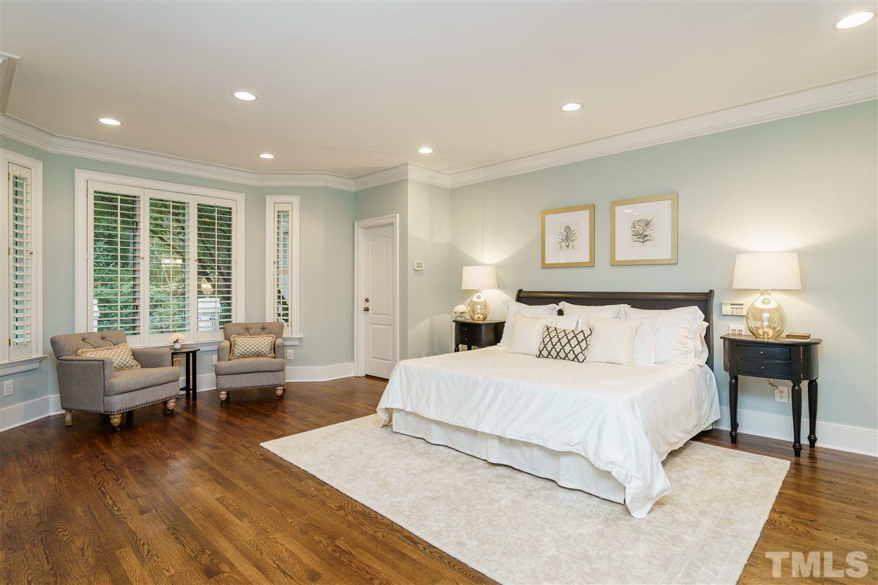 7628 Rainwater Road Raleigh, NC 27615 - Photo 15 of 25 a spacious bedroom with a large bed and a couch