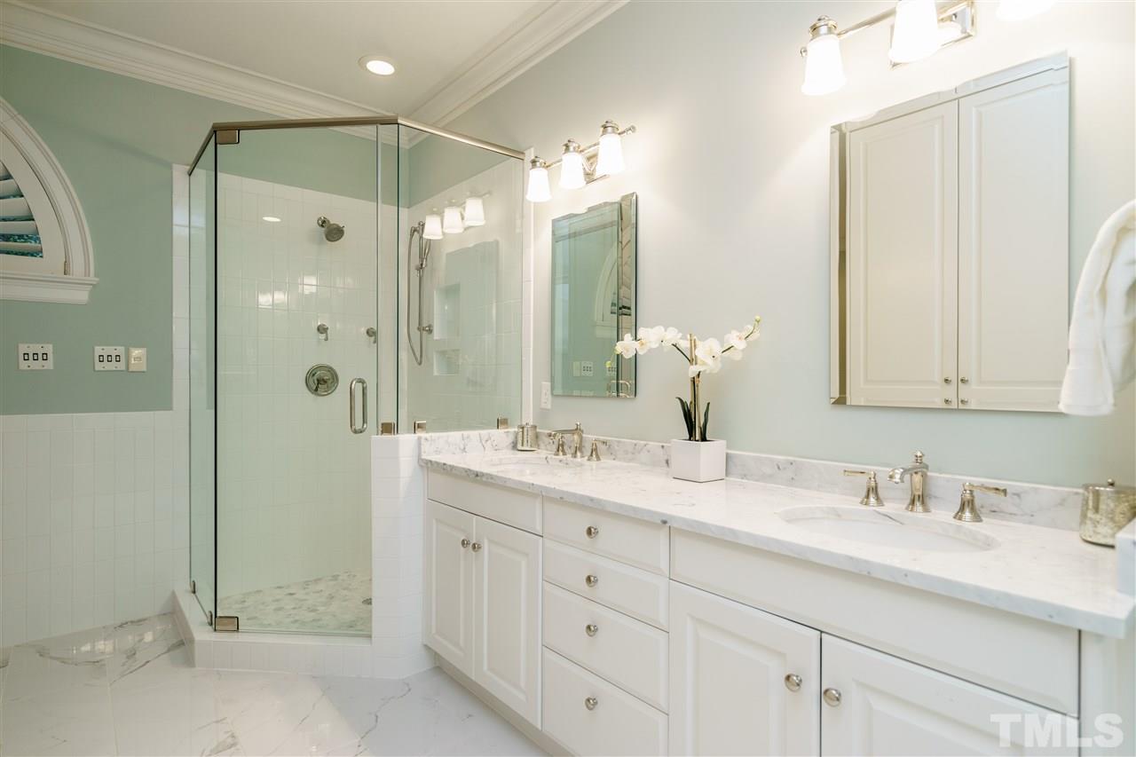7628 Rainwater Road Raleigh, NC 27615 - Photo 17 of 25 a bathroom with a double vanity sink mirror and shower