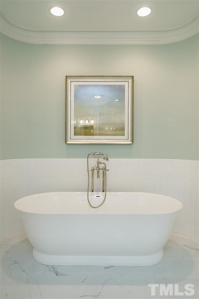 7628 Rainwater Road Raleigh, NC 27615 - Photo 18 of 25 a white bath tub sitting next to a white wall