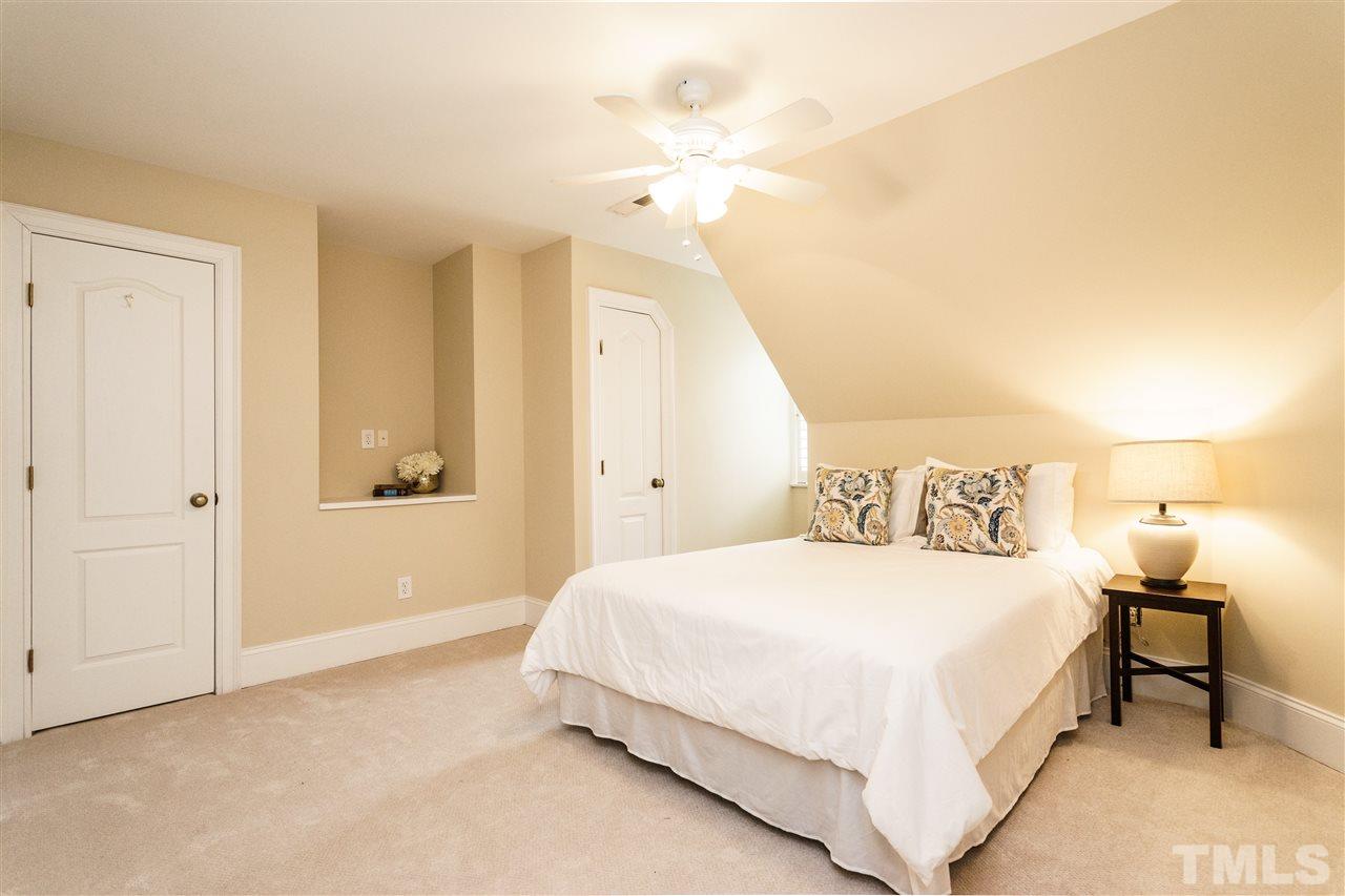 7628 Rainwater Road Raleigh, NC 27615 - Photo 21 of 25 a bedroom with a bed and a night stand