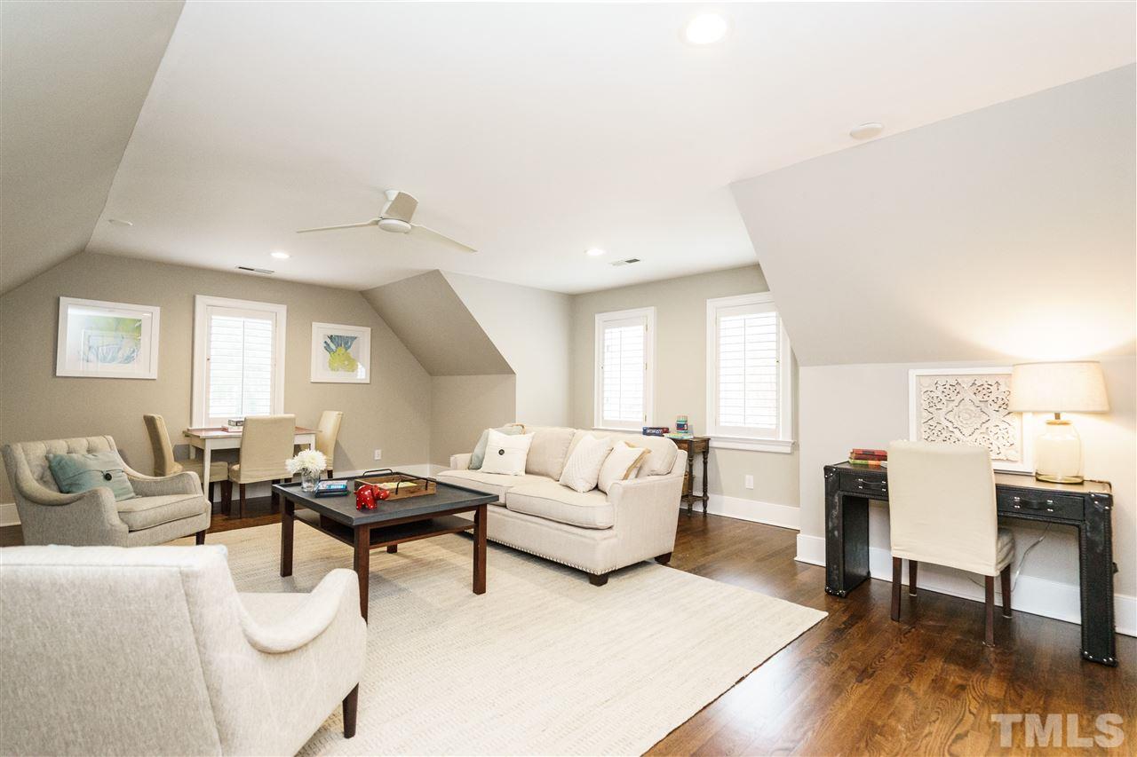 7628 Rainwater Road Raleigh, NC 27615 - Photo 22 of 25 a living room with furniture and a wooden floor