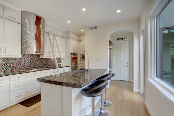 a kitchen with a sink and a stove top oven