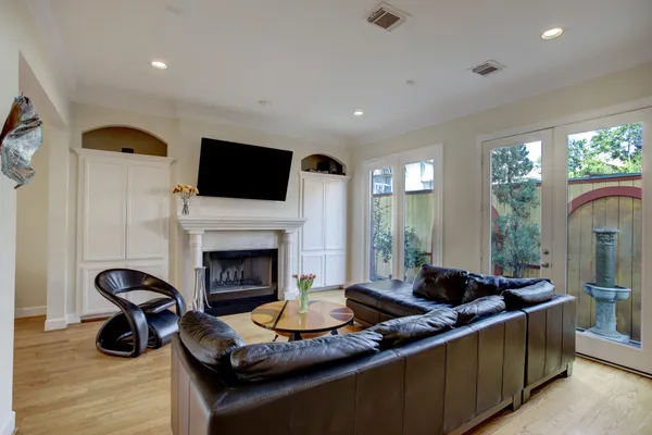 a living room with furniture a fireplace and a flat screen tv