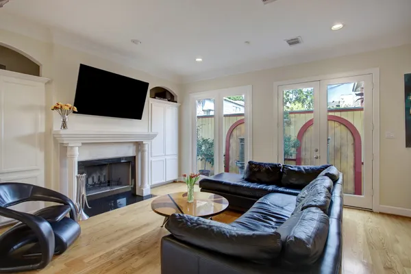 a living room with furniture a fireplace and a chandelier