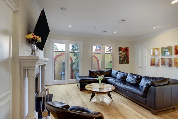 a living room with furniture and a wooden floor