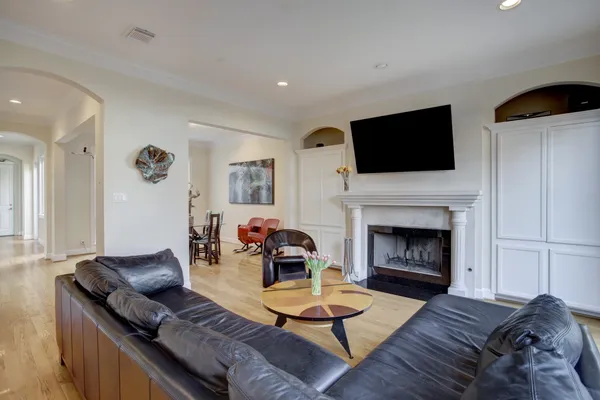 a living room with furniture a flat screen tv and a fireplace