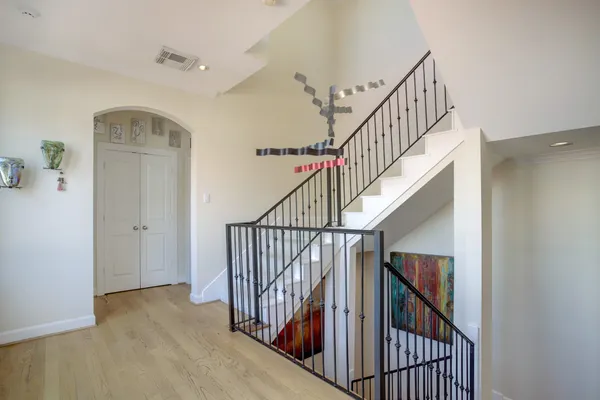 a view of staircase with railing and white walls
