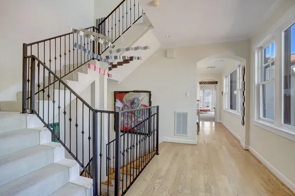 a view of staircase with railing and white walls