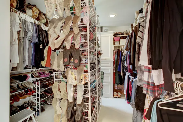 walk in closet with clothes