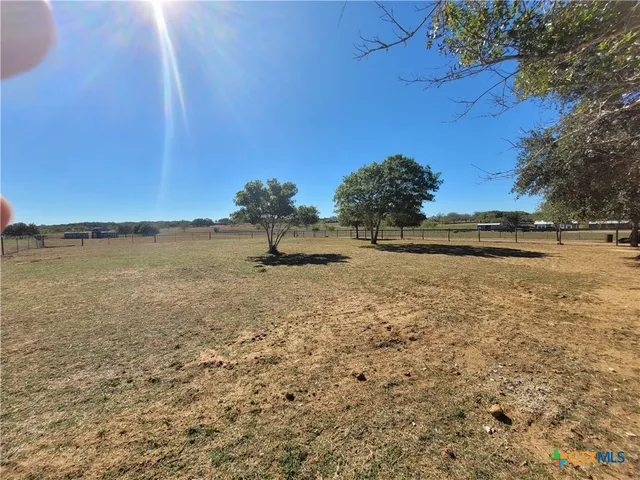 a kitchen with stainless steel appliances granite countertop a stove refrigerator and microwave