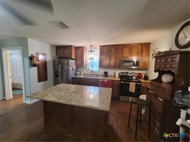 a bathroom with a shower curtain and a window