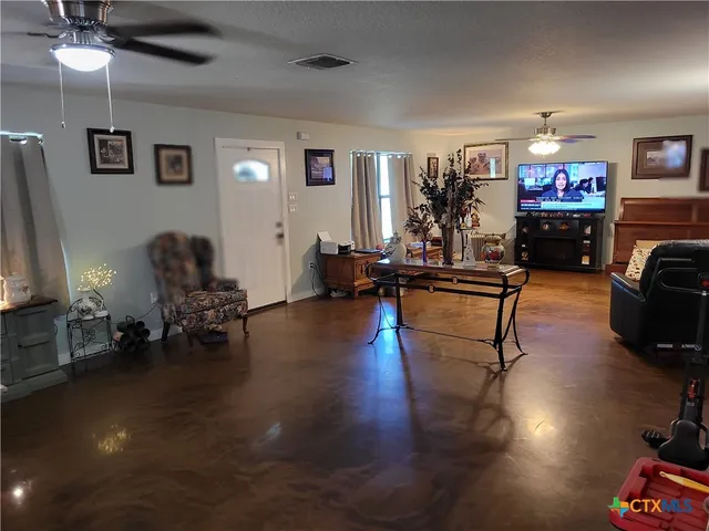 a kitchen with stainless steel appliances granite countertop a sink stove refrigerator and cabinets