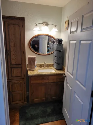 a kitchen with refrigerator cabinets and wooden floor