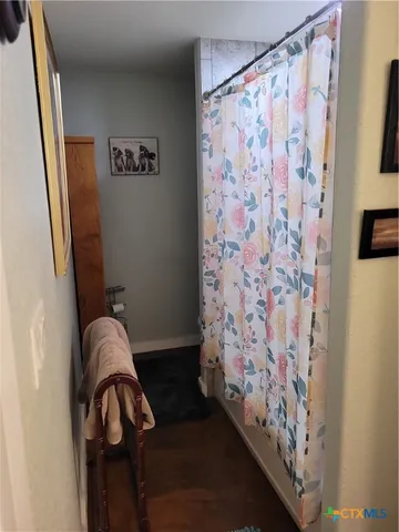 a view of an empty room and kitchen