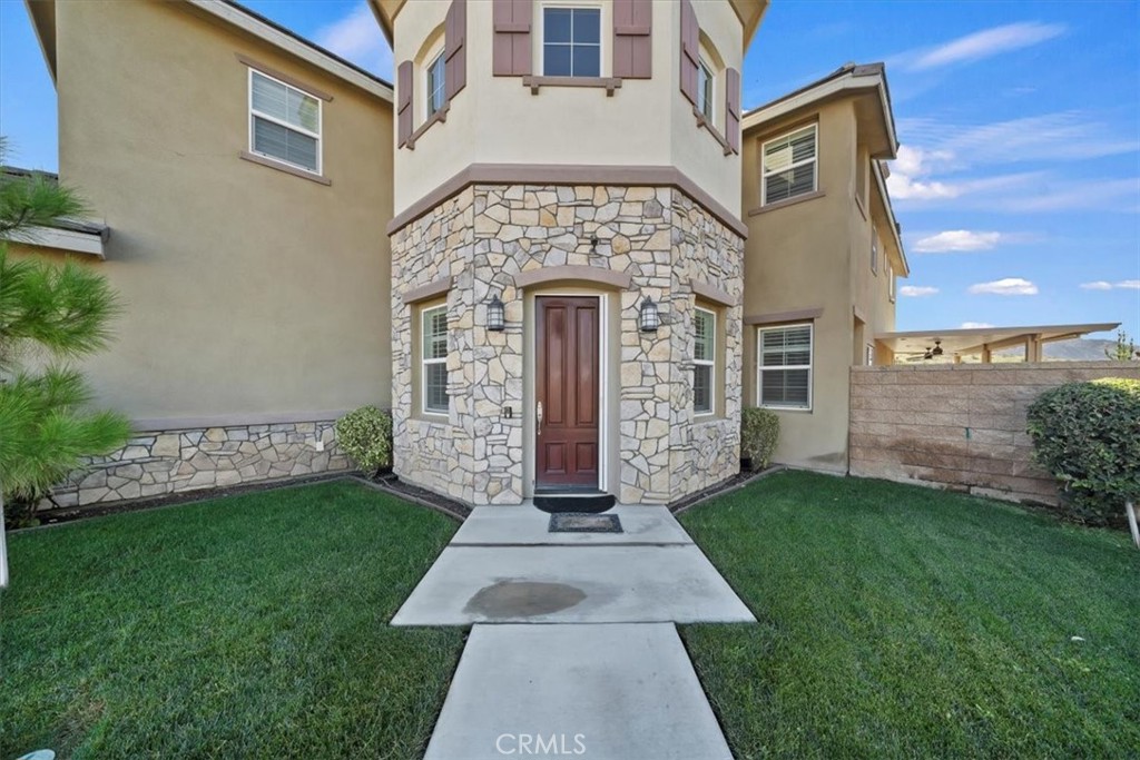 3094 Crystal Ridge Lane Colton, CA 92324 - Photo 11 of 68 front view of a brick house with a yard