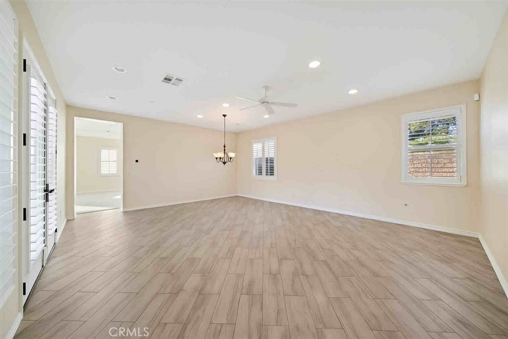 3094 Crystal Ridge Lane Colton, CA 92324 - Photo 21 of 68 an empty room with wooden floor and windows