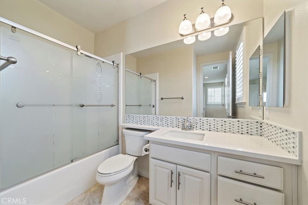 3094 Crystal Ridge Lane Colton, CA 92324 - Photo 39 of 68 a bathroom with a sink a toilet and a mirror