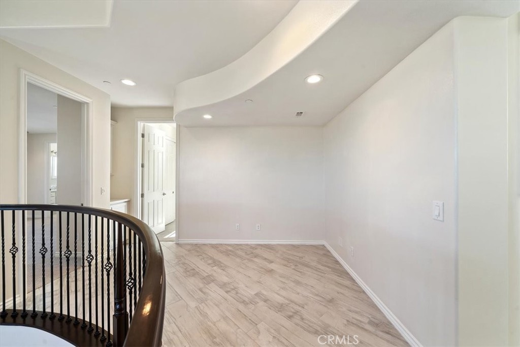 3094 Crystal Ridge Lane Colton, CA 92324 - Photo 40 of 68 a view of a hallway with wooden floor