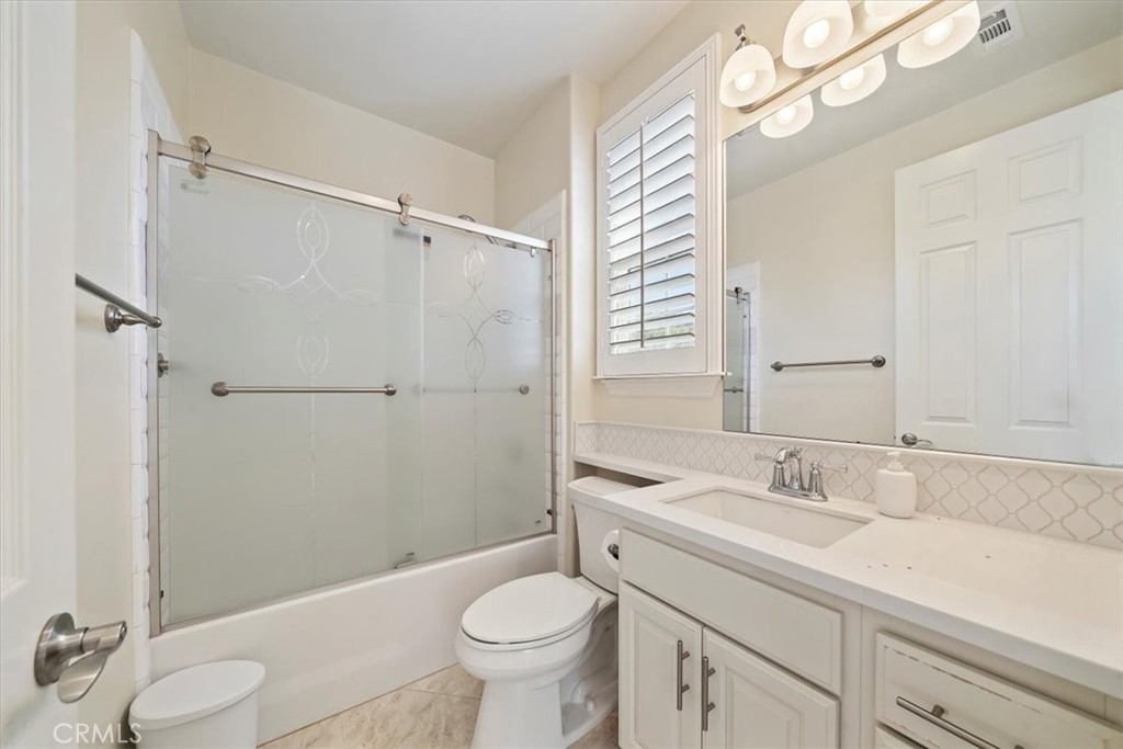 3094 Crystal Ridge Lane Colton, CA 92324 - Photo 43 of 68 a bathroom with a sink toilet a mirror and shower