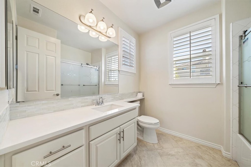 3094 Crystal Ridge Lane Colton, CA 92324 - Photo 46 of 68 a bathroom with a sink a toilet and a large mirror