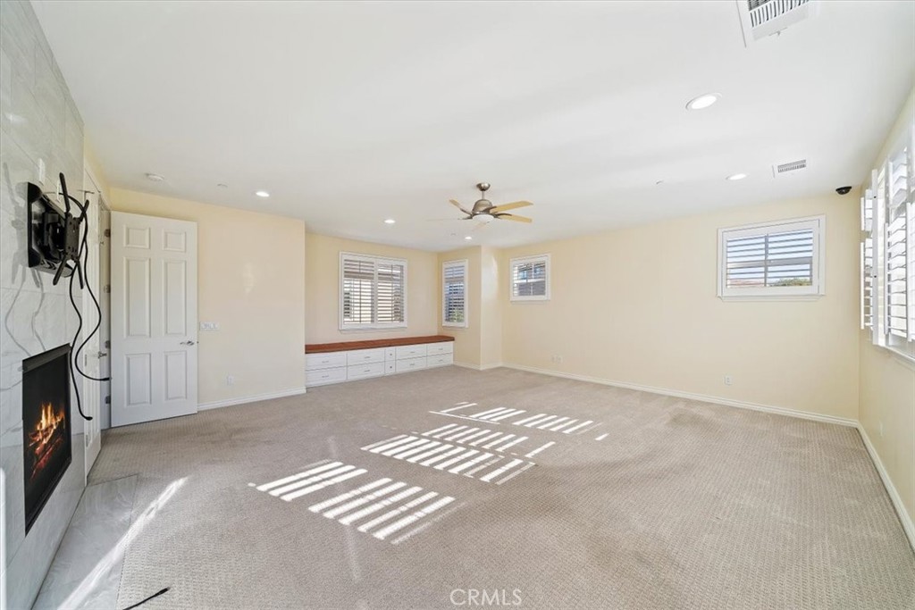 3094 Crystal Ridge Lane Colton, CA 92324 - Photo 47 of 68 a view of an empty room with a fireplace and a window