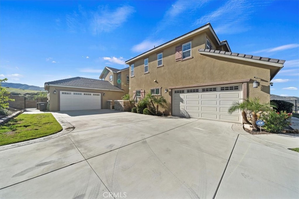 3094 Crystal Ridge Lane Colton, CA 92324 - Photo 6 of 68 a front view of a house with a yard and garage