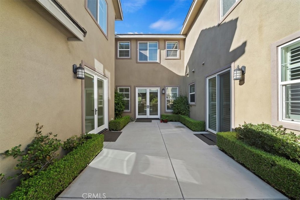 3094 Crystal Ridge Lane Colton, CA 92324 - Photo 10 of 68 a view of a brick house with many windows next to a yard