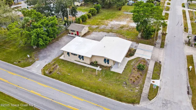 an aerial view of a house with swimming pool