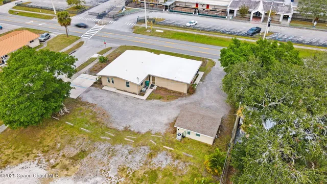 an aerial view of a house with swimming pool