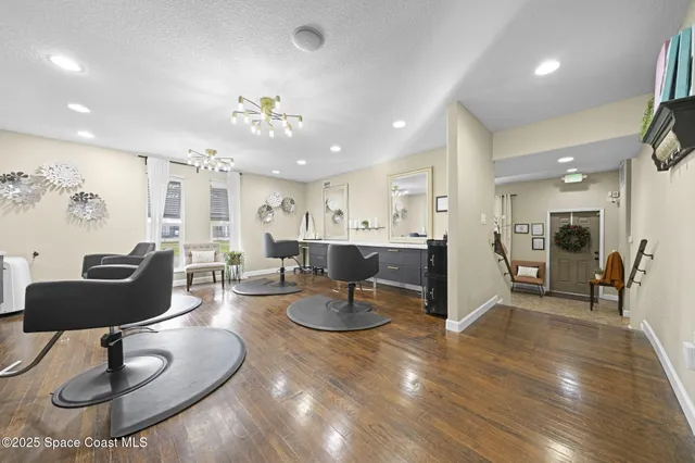 a living room with furniture and kitchen view