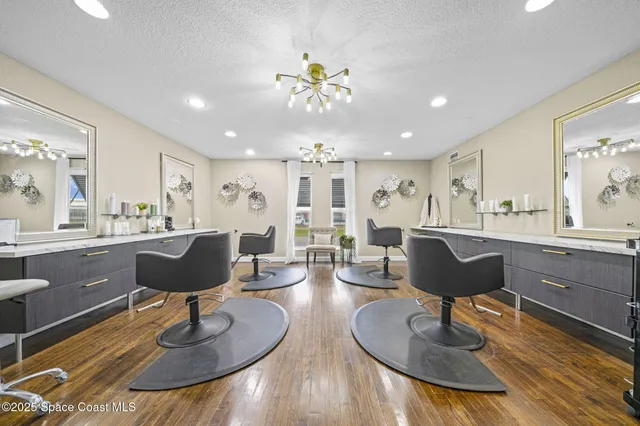a living room with lots of furniture and view of kitchen
