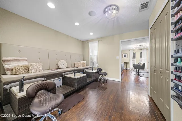 a living room with furniture and wooden floor