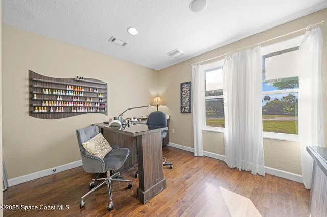 a workspace with furniture window and wooden floor