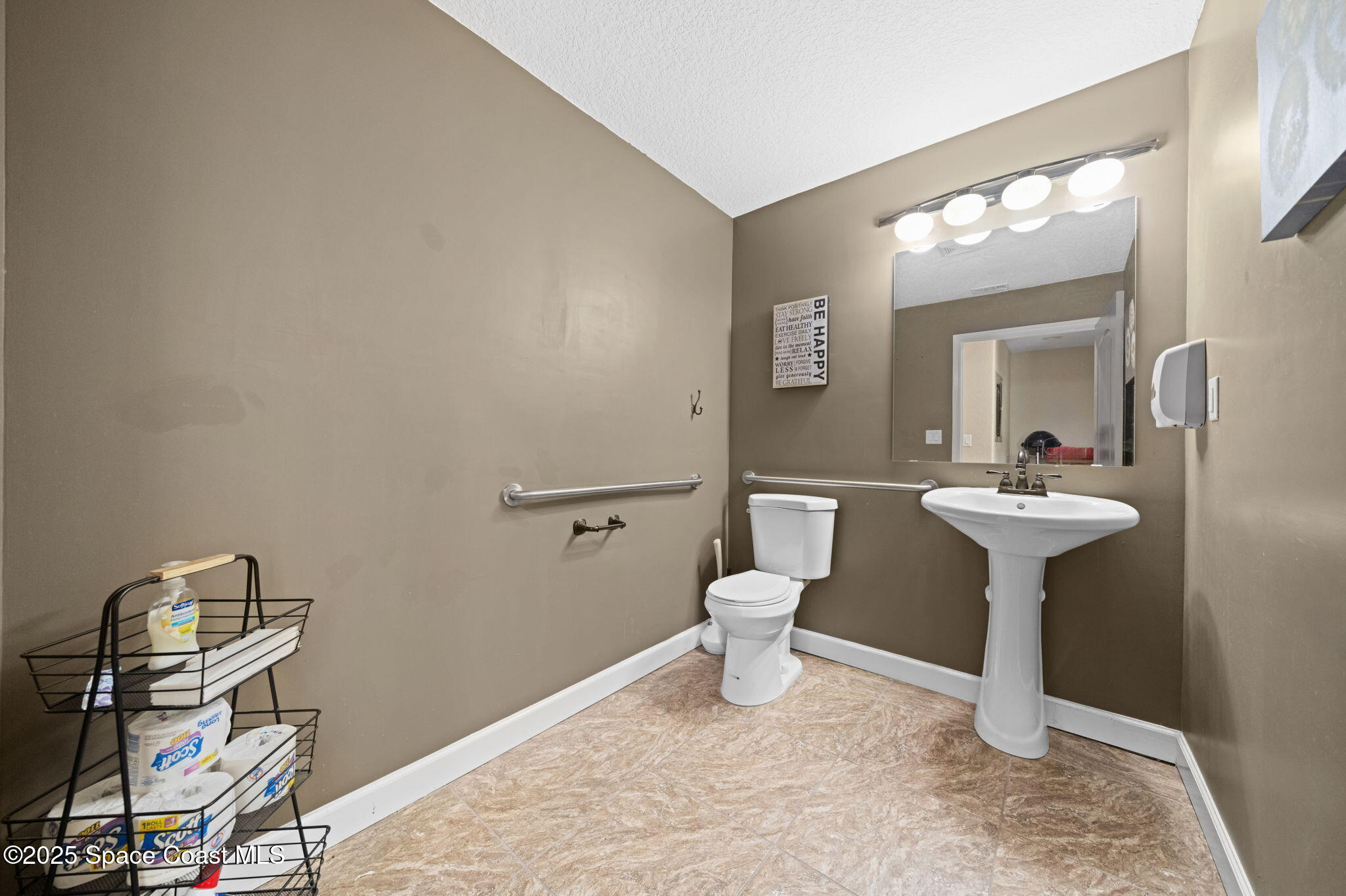 290 Parnell Street Merritt Island, FL 32953 - Photo 34 of 48 a bathroom with a sink a toilet and mirror