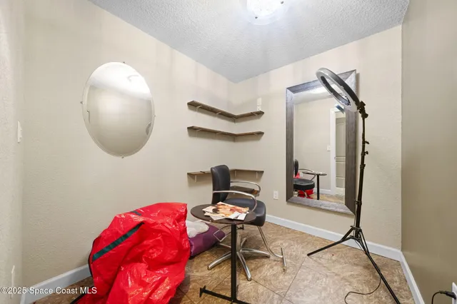 a living room with furniture and a mirror