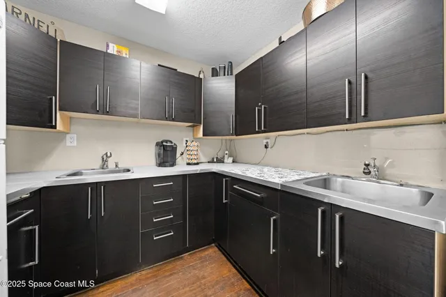 a kitchen with a sink cabinets and appliances