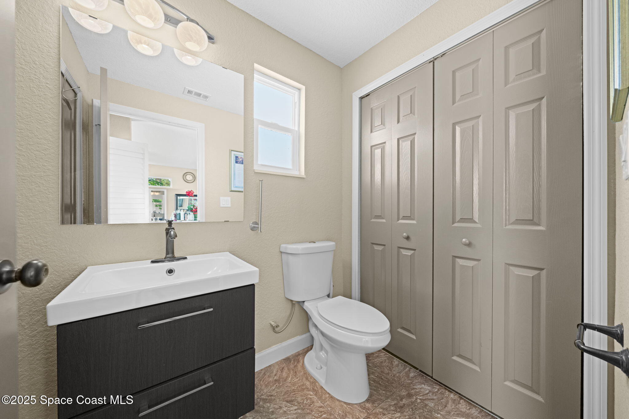 290 Parnell Street Merritt Island, FL 32953 - Photo 44 of 48 a bathroom with a sink a toilet and shower