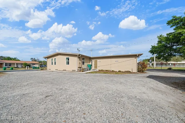 a big house with a big yard and large trees
