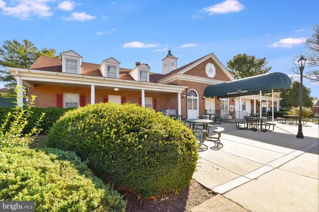a front view of a house with swimming pool and sitting area