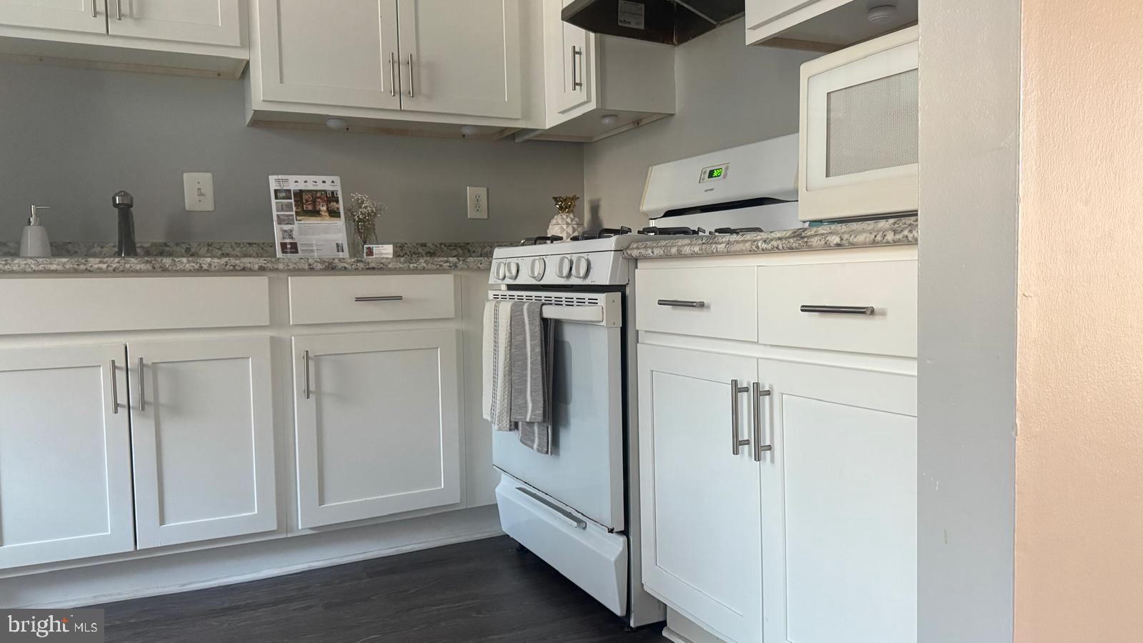 762 Quince Orchard Boulevard, Unit 101 Gaithersburg, MD 20878 - Photo 7 of 21 a kitchen with stainless steel appliances granite countertop white cabinets and a sink