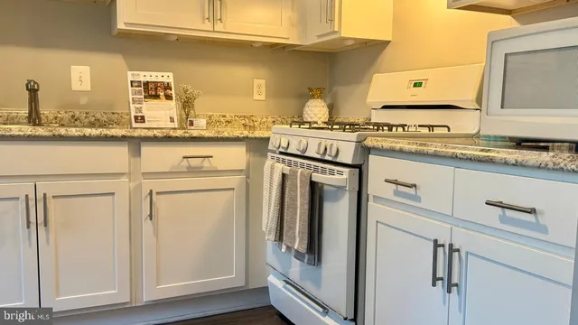 a kitchen with stainless steel appliances granite countertop a sink and cabinets