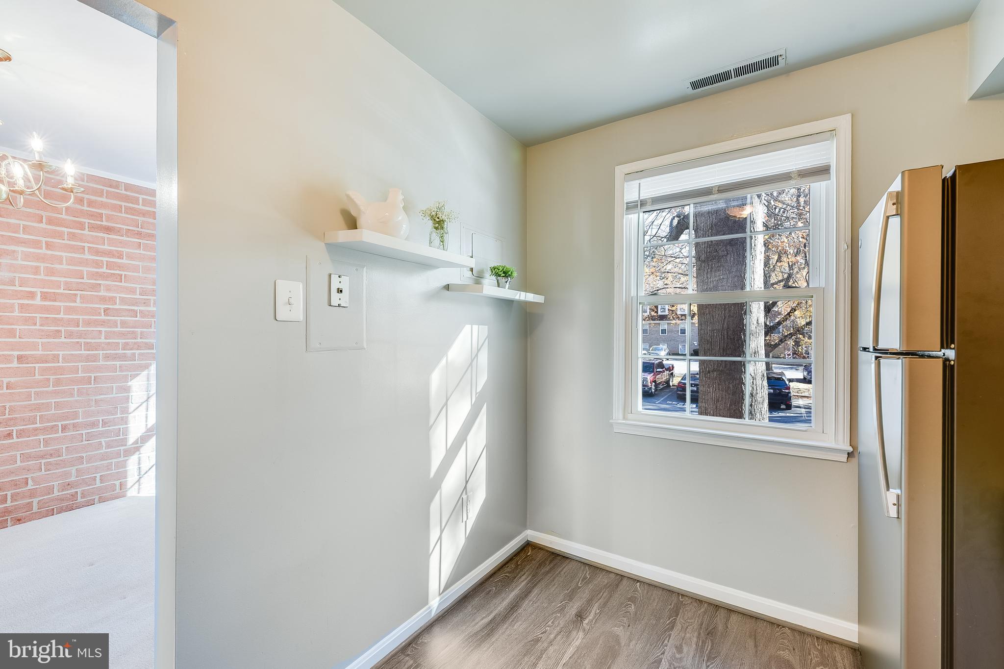762 Quince Orchard Boulevard, Unit 101 Gaithersburg, MD 20878 - Photo 10 of 21 a view of a kitchen with wooden floor and a window