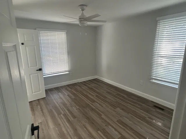 wooden floor in an empty room with a window