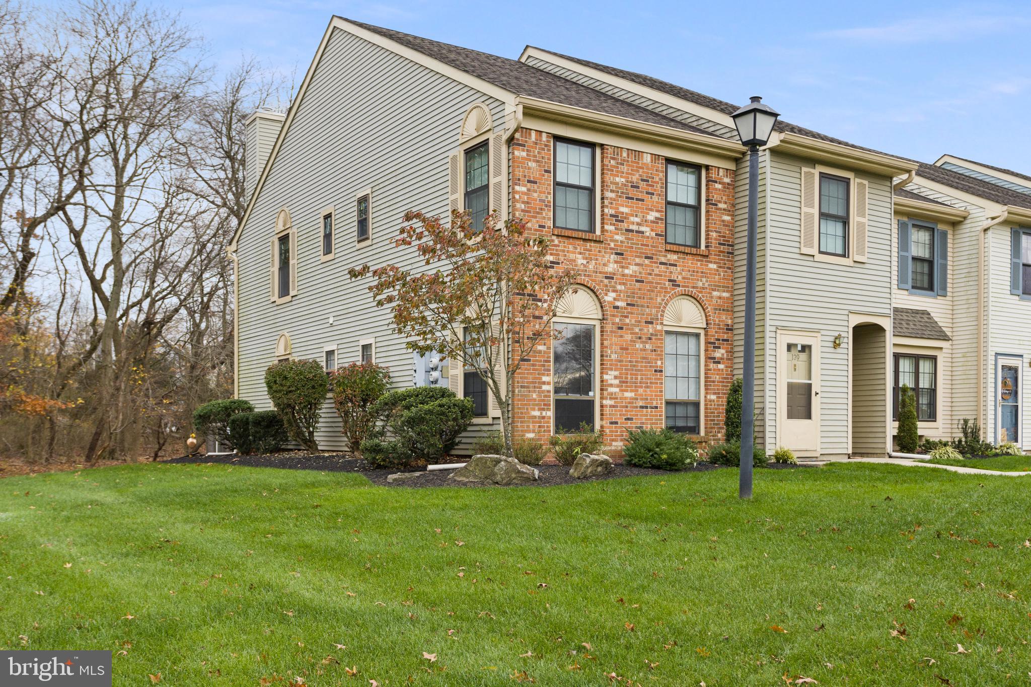 a front view of a house with a garden and plants