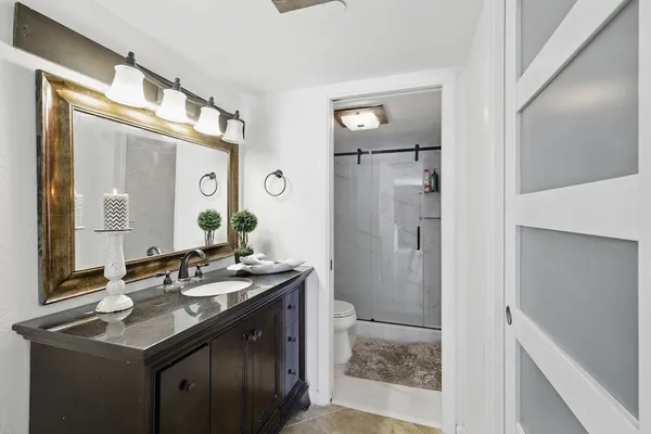 a bathroom with a glass shower door