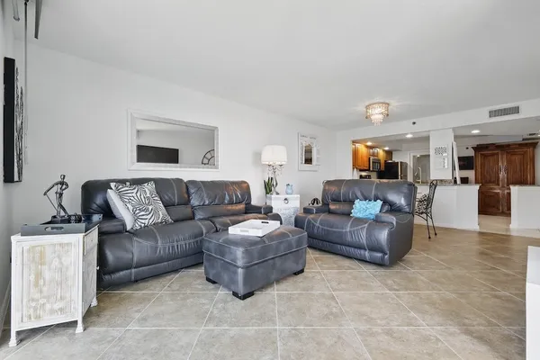 a living room with furniture and a wooden floor